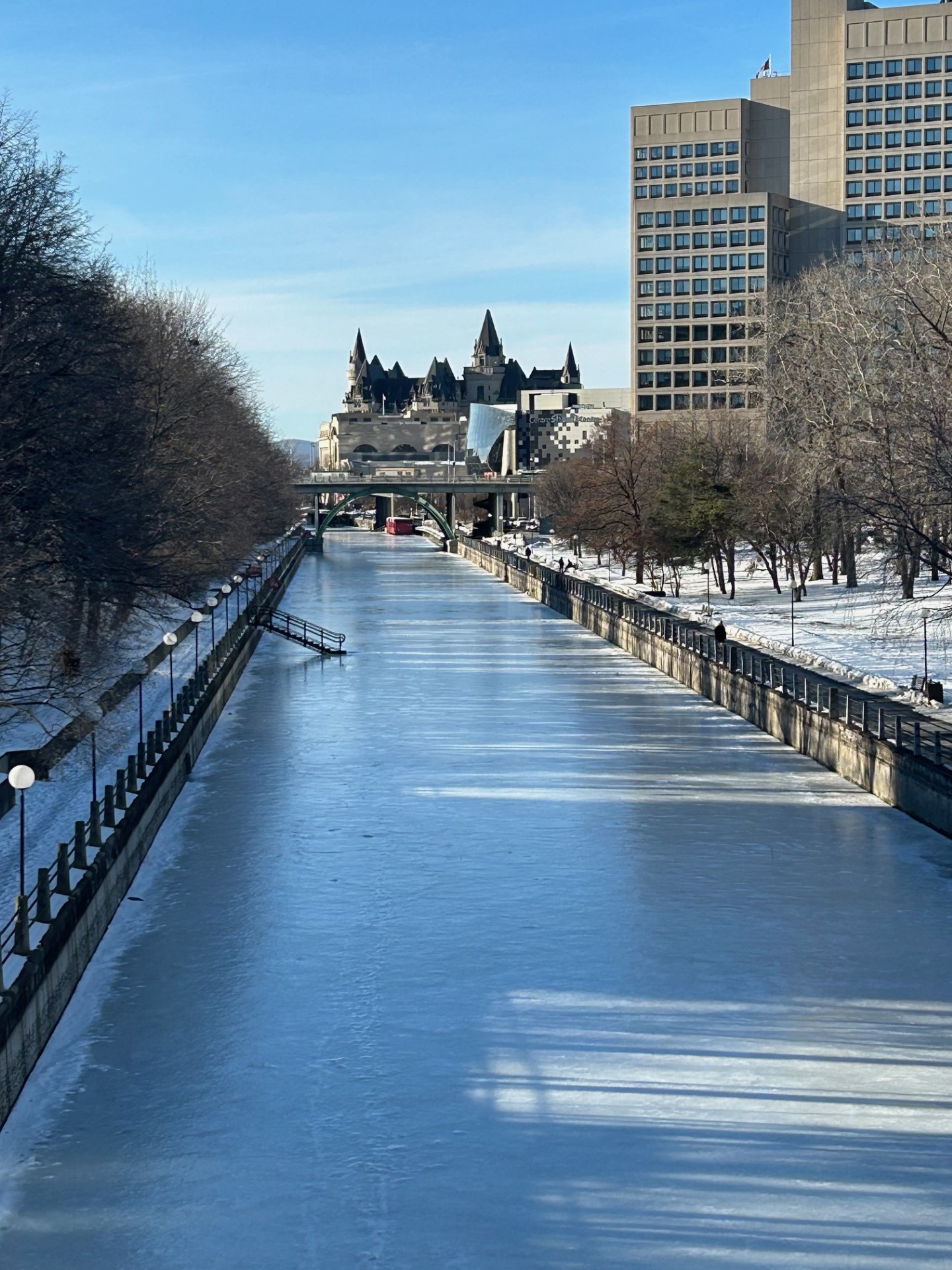 Rideau Canal with ice looking good and no one skating. Parliament in the background.